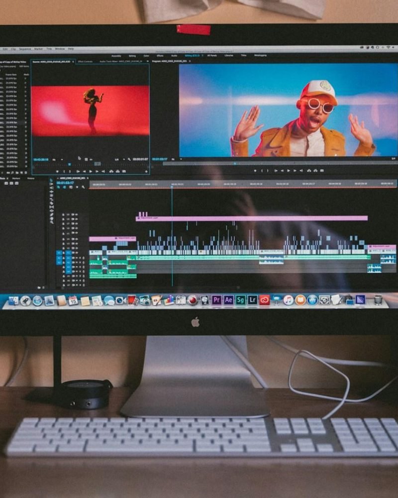 turned on iMac and Apple Magic Keyboard and mouse on table