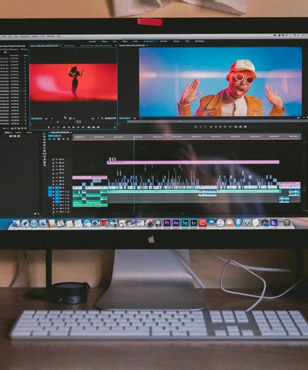 turned on iMac and Apple Magic Keyboard and mouse on table